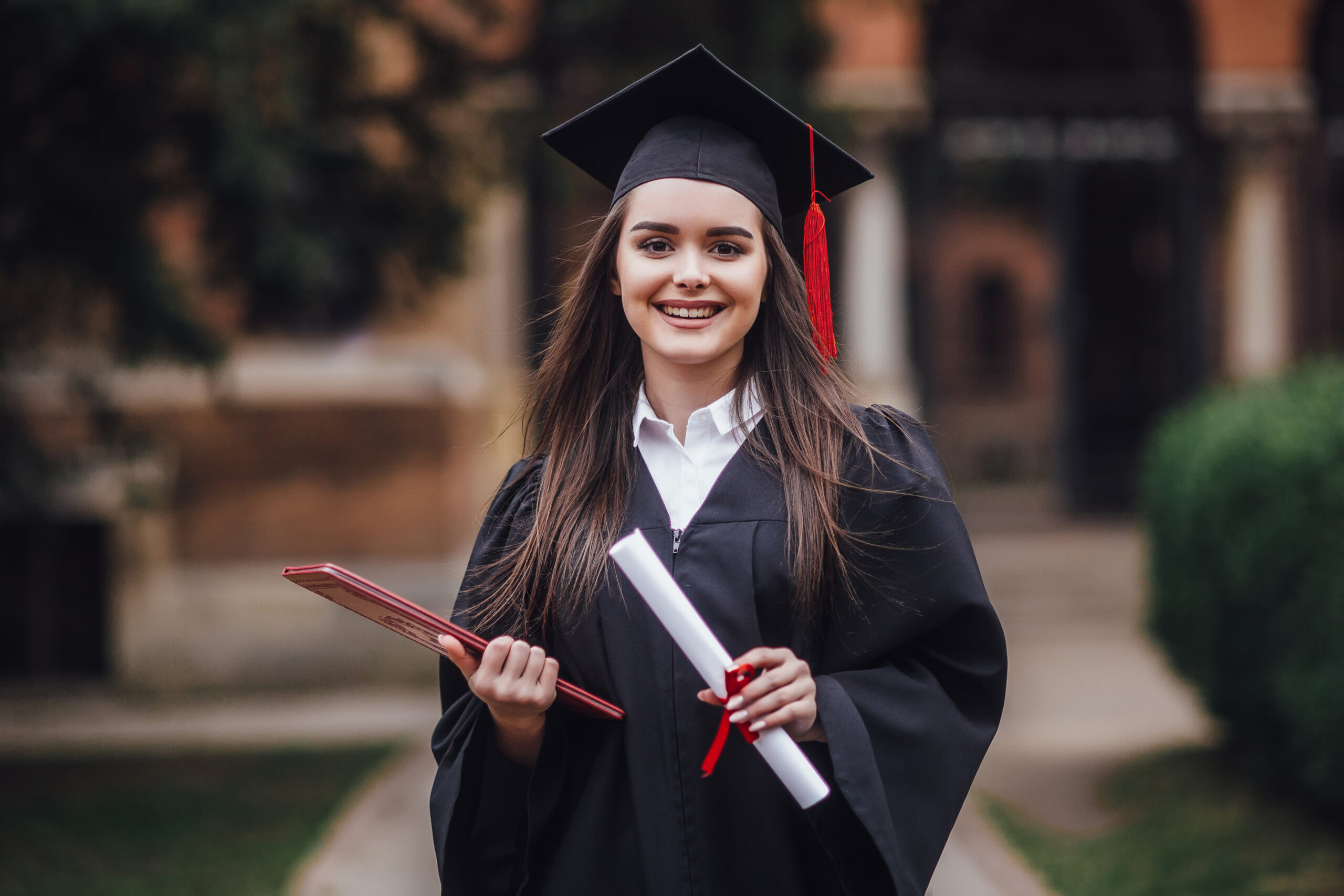 female-student-graduate-is-standing-university-hall-mantle-smiling-with-diploma-hands
